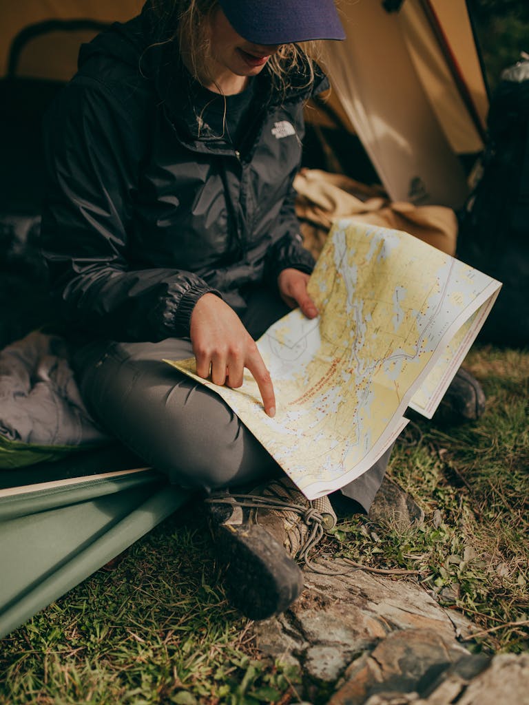 Photo of Woman Sitting While Pointing on World Map